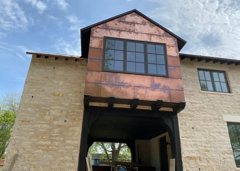 Copper metal panel facade on a stone building for Skylight Installation in Oak Creek