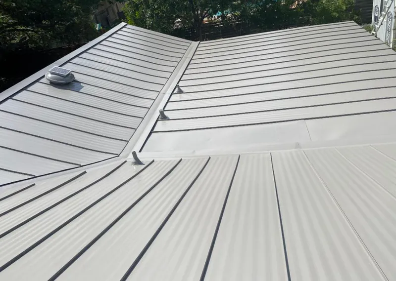 Solar attic fan installed on a metal roof for Roof Ventilation in Oak Creek